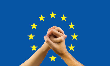a woman and a man in his hands with a flag of europe background in concept of unity