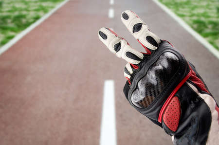 gesture of biker greeting on the road. typical sign for greeting to another bikers in the wayの写真素材