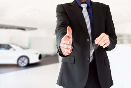 handshake of a businessman in an auto rental and sale of carsの写真素材