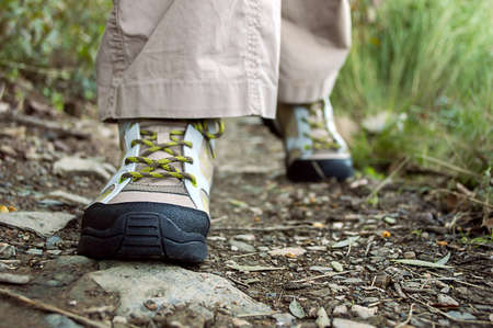 Front view of a hiker walking along a trailの写真素材