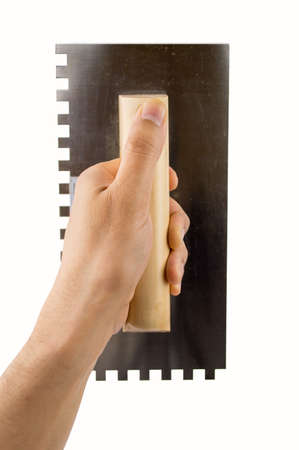 craftsperson holding the trowel over white wallの写真素材