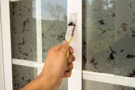 detail of hand painting white window with the brushの写真素材