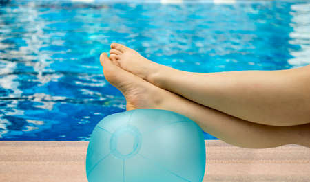 relaxed person with feet above the ball on the poolの写真素材