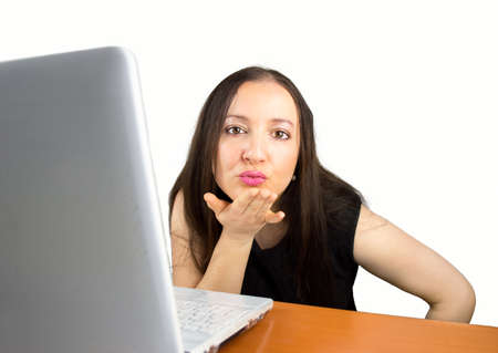 woman sending a kiss while surfing the internetの写真素材