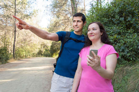 couple on hiking using internet with smartphone as guideの写真素材