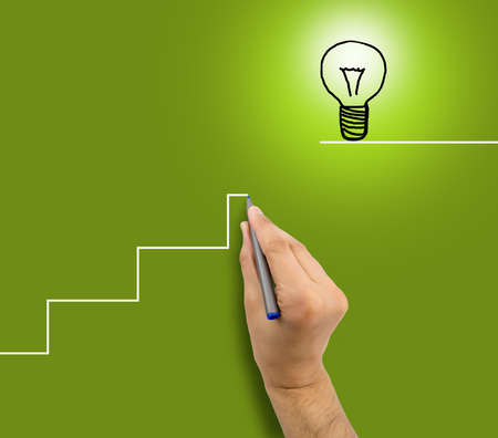 man drawing a staircase to success in business.の写真素材