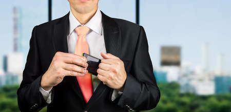 businessman keeping his mobile phone before a meetingの写真素材