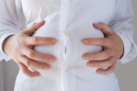 close up of a fat woman with stomach pain