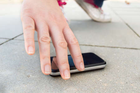 lucky man finding a phone on the streetの写真素材