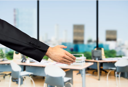 Closeup of a businessman welcoming officeの写真素材