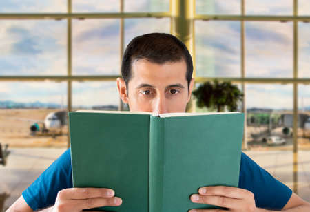 traveler reading a book in the waiting room of an airportの写真素材