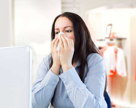 saleswoman with a cold at the boutiqueの写真素材