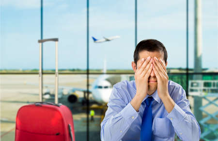 crying businessman who delayed flight at an airportの写真素材