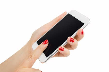 woman hand holding a smartphone with painted nails manicure in redの写真素材