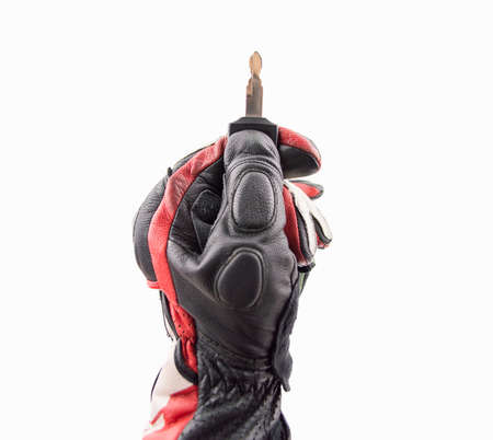 man with biker gloves holding a car key with remote  isolated on white backgroundの写真素材
