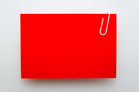 red visit card with clip on white backgroundの写真素材