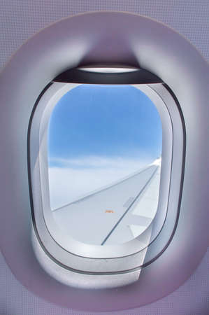 Looking through window of aircraft during the flight  in wing with a nice blue skyの写真素材