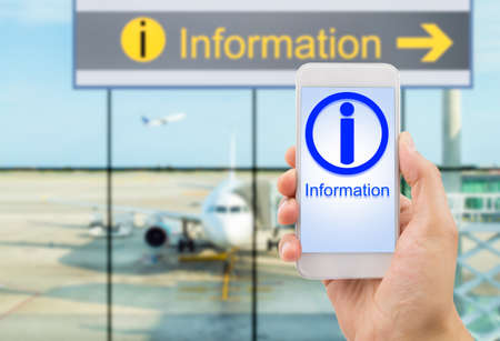 hand holding the smartphone searching information at the lobby airport. All screen content is designed by us and not copyrighted by others and created with digitizing tablet and image editorの写真素材