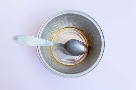 closeup of container of custard with spoonの写真素材