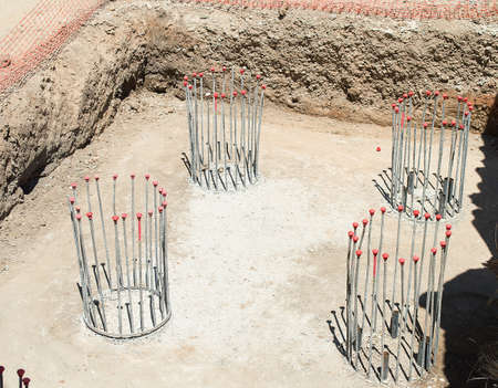 group of pillars concrete under construction with reinforced steel rods or bars used to reinforce concreteの写真素材
