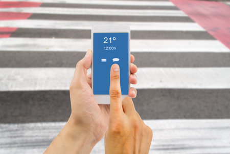 hands crossing a crosswalk using the smartphone like a concept of distraction and risk of abuse of...