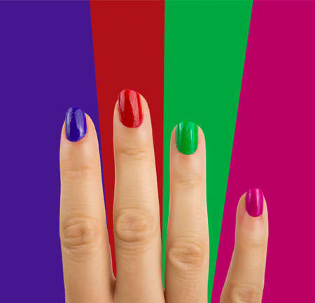 Multi colored manicure in light and dark colors of lacquer on a striped background.の写真素材