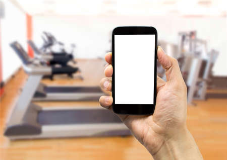 hand holding a smartphone at the gymの写真素材