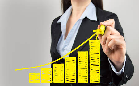 cropped shot of a businesswoman drawing a growth chart of the benefitsの写真素材