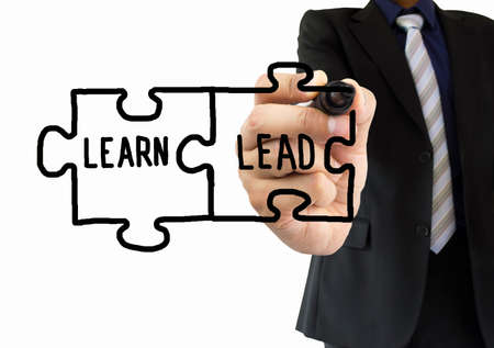 executive drawing on the wipeboard the learning and the lead are two pieces of the puzzle. All screen content is designed by us and not copyrighted by others and created with digitizing tablet and image editorの写真素材