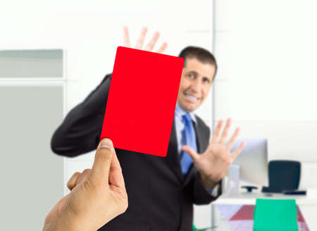 businessman fired by his boss with a red cardの写真素材