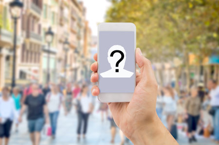 Mobile concept question man hands holding a mobile phone screen with a question mark in a big city...