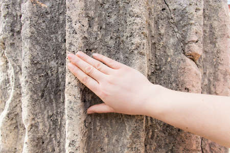 hand touching an ancient column as concept of love to historical architectureの写真素材