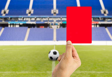 Football referee showing you the red card and expelled with stadium backgroundの写真素材