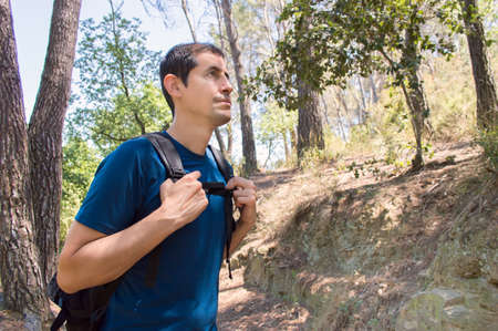 portrait of hiker with backpack at a mountain trail in summertimeの写真素材