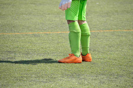 Cropped shot of a young boy foot on a soccerの写真素材