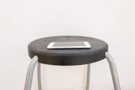 Forgotten smartphone on a chair at a waiting room