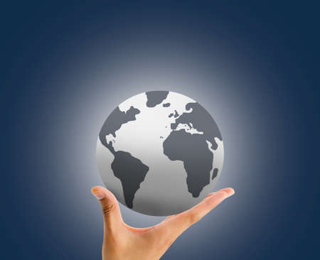 hand holding the globe with the palm over blue backgroundの写真素材