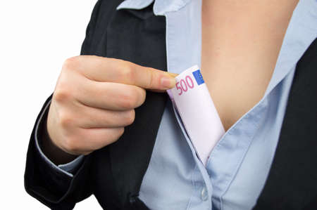 closeup of businesswoman is hiding the banknotes in her decolleteの写真素材
