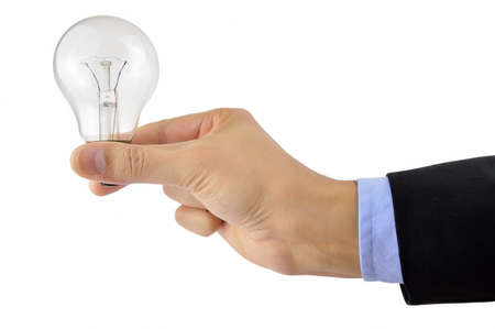 hand of a businessman with a light bulb as idea concept in a white backgroundの写真素材