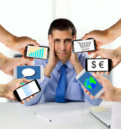 business man overwhelmed with so much work at the officeの写真素材