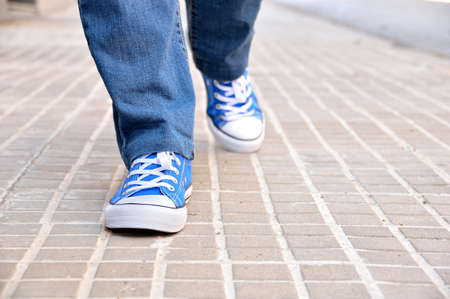 close up of front view of a young walking along a streetの写真素材