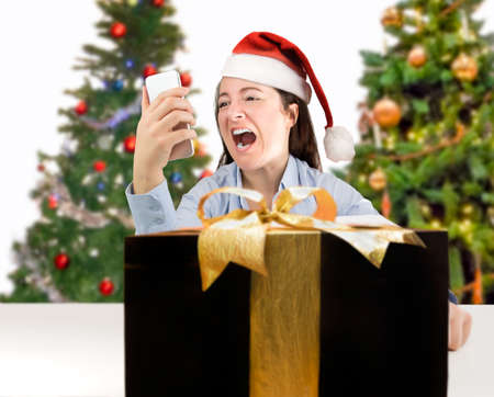 Angry female screaming into a smart phone because they have not sent the right giftの写真素材