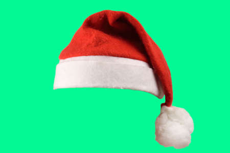 Christmas santa hat isolated on green background. designed to easily put on persons head.の写真素材
