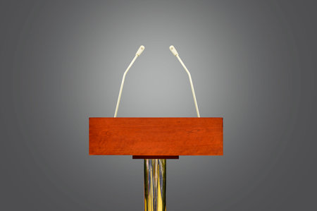 An empty podium and microphones isolated over gray background