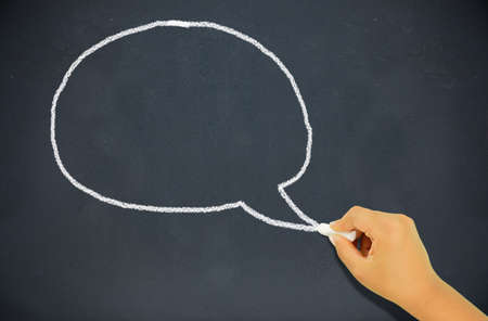 Speech bubble boy student blackboard. boy drawing on black chalkboard. Funny image of caucasian male college student.の写真素材