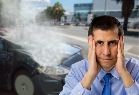 man lamenting not having car insurance after an accident car in the city