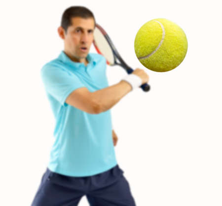 portrait of a male tennis player hitting the ball with racquet isolated over white backgroundの写真素材