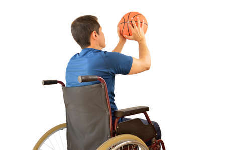 rear view of a basketball player in free throw pose in wheelchair isolated in white backgroundの写真素材