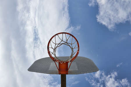 view from down of a Basketball hoop over blue sky backgroundの写真素材