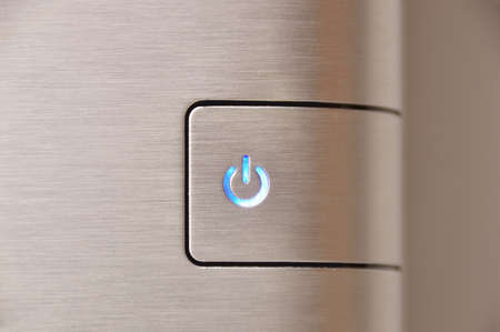 Close up of finger pressing ON-OFF button の写真素材